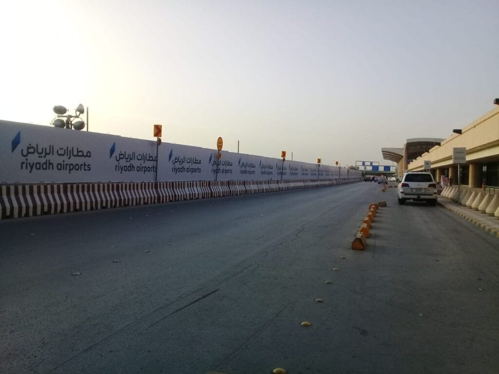 Wayfinding signage project at Riyadh Airport in Saudi Arabia showing directional signage and branded construction hoarding by Kaiian Agency