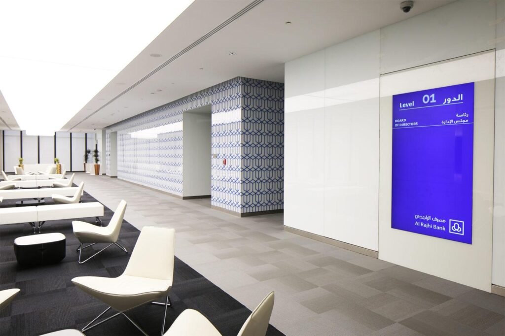 Wayfinding signage system with directional signs inside a modern commercial building.
